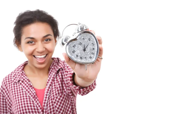 Smiling mulatto girl showing alarm clock — Stock Photo, Image