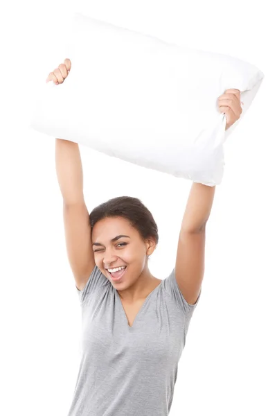 Smiling mulatto girl holding pillow up — Stock Photo, Image