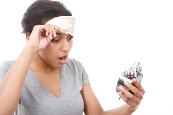 Pretty woman looking at alarm clock — Stock Photo, Image