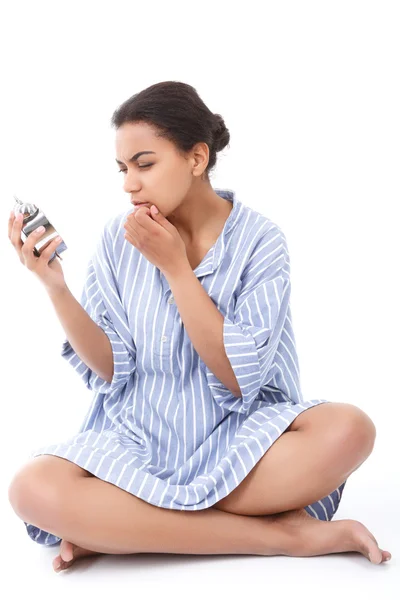 Pretty young mulatto girl holding alarm clock — Stock Photo, Image