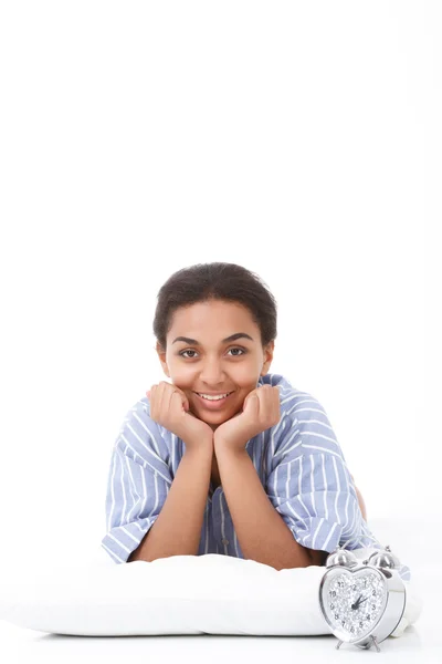 Smiling lying mulatto girl on pillow — Stock Photo, Image