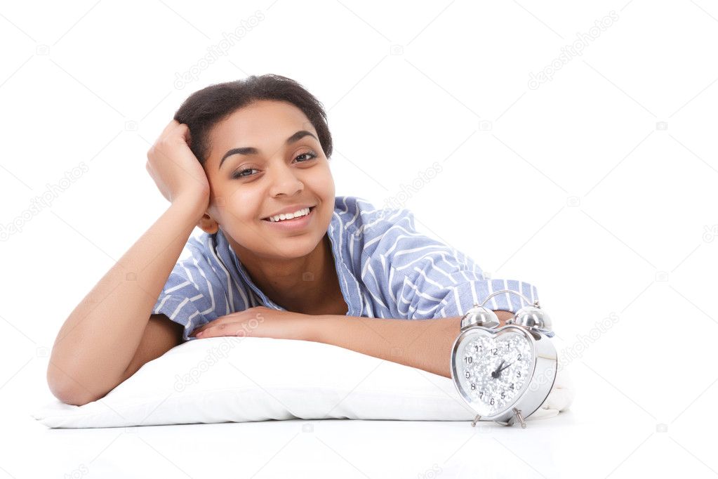 Smiling lying mulatto girl on pillow 