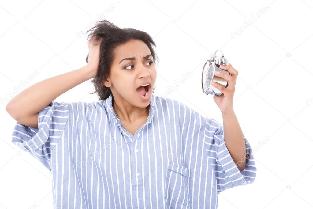 Excited young woman with alarm clock 