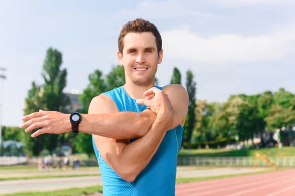 Handsome young man doing stretching — Stock Photo, Image