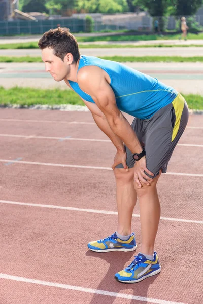 Tired young sportsman after exercising — Stock Photo, Image