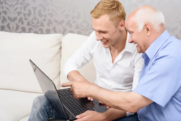 Grandfather and grandson with laptop — Stock Photo, Image