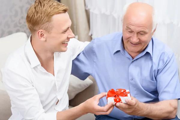 Abuelo y nieto con un pequeño regalo — Foto de Stock