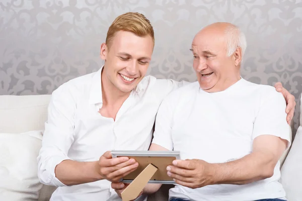 Grandfather and grandson with photo in frame — Stock Photo, Image