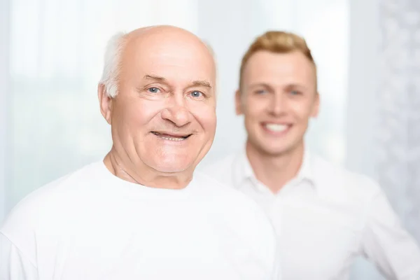 Close-up of grandson and grandfather