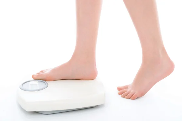 Legs of a woman on weighting machine — Stock Photo, Image