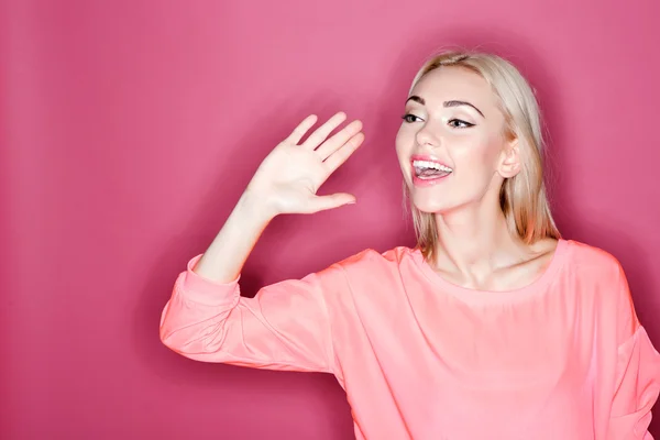 Happy young woman greeting somebody — Stock Photo, Image