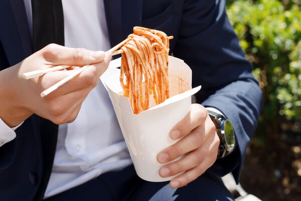 Close-up of man eating Chinese noodles