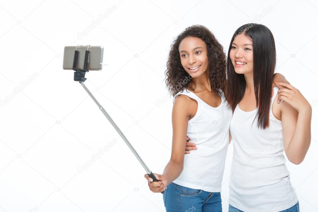 Smiling friends making selfie 