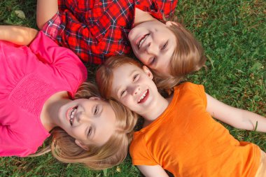 Top view of children lying on the groung 