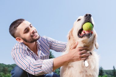 Happy man with his golden retriever