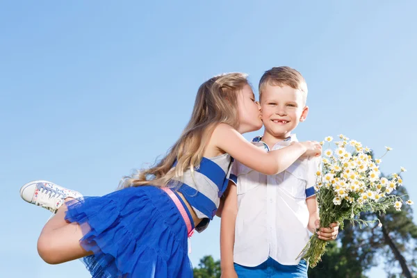 Pleasant little boy and girl kissing. — Stock Photo, Image