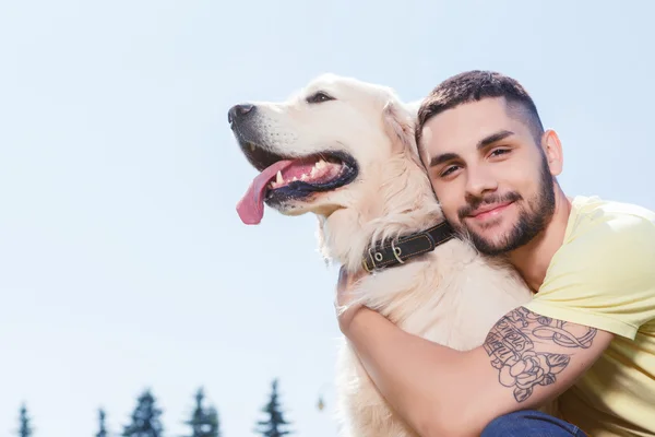 Handsome guy with his dog — Stock Fotó