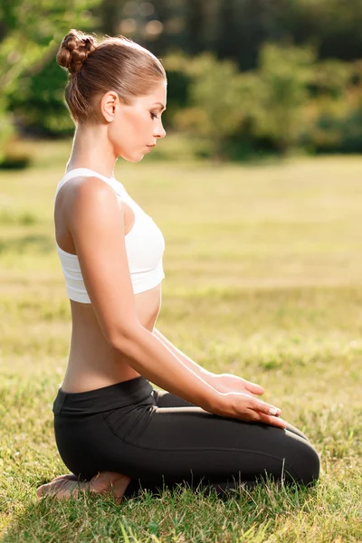 Pleasant young woman practicing yoga — 图库照片