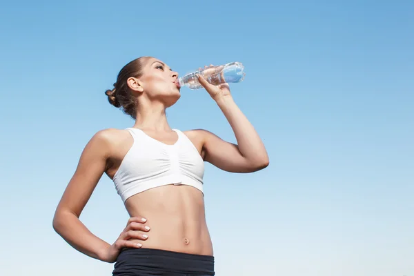 Pleasant young woman drinking water — ストック写真