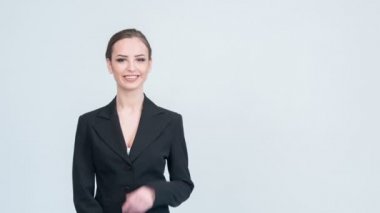 Woman in suit showing with her hand.