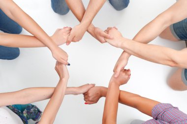 Group of people making ring with hands