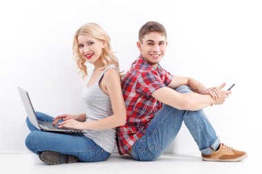 Man and woman with mobile phone, laptop
