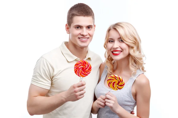 Smiling man and woman with candies — Stock Photo, Image