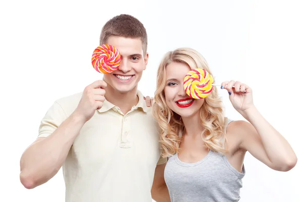 Smiling man and woman with candies — 스톡 사진