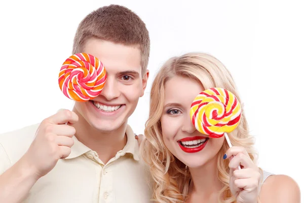 Smiling man and woman with candies — 스톡 사진