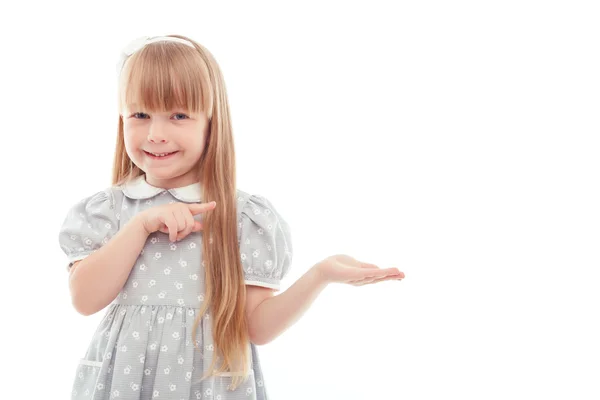 Surprised little girl pointing left — Stock Photo, Image