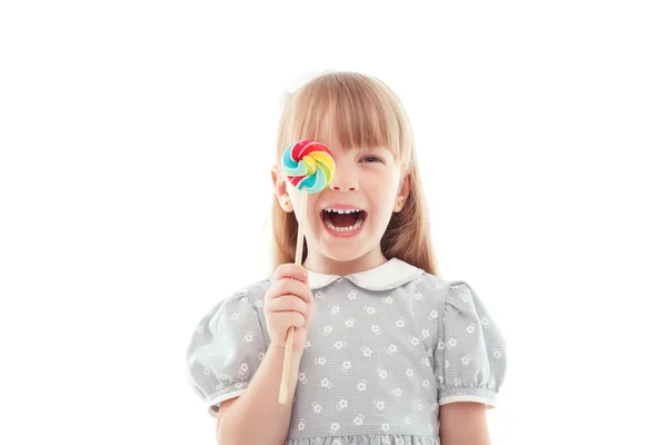 Little laughing girl holding candy — Stock Photo, Image