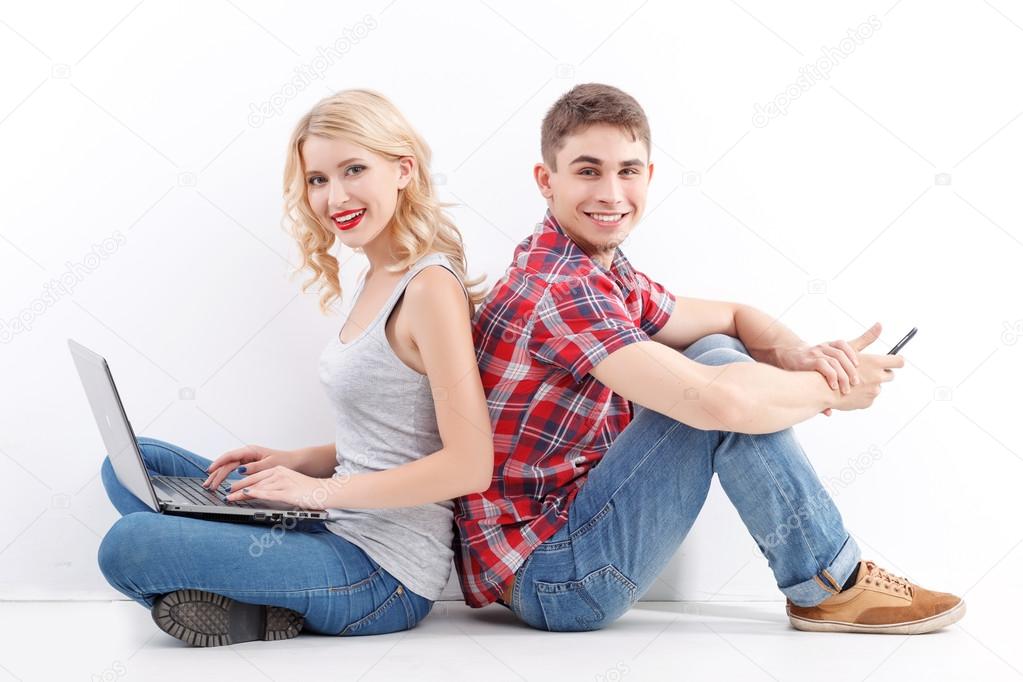 Man and woman with mobile phone, laptop