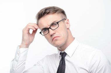 Confused man touching his head with fingers