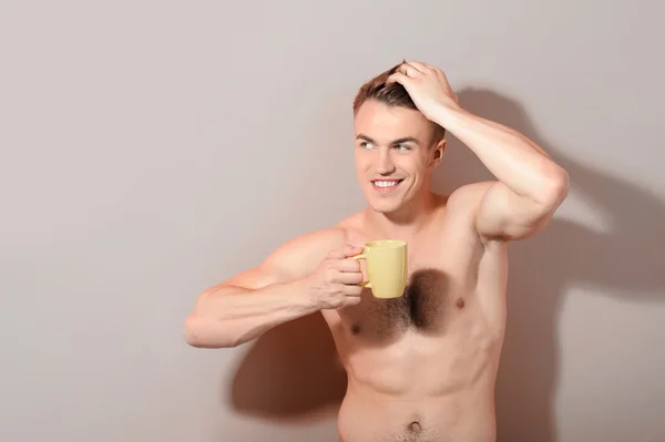 Handsome topless man holding cup of coffee — Stock Photo, Image