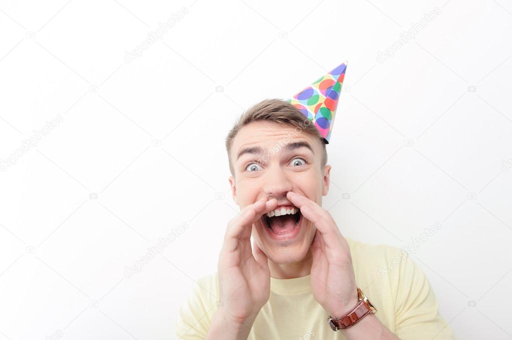 Close-up of crazy man wearing birthday hat