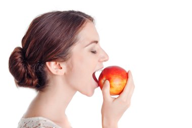 Pleasant young  girl eating  apple