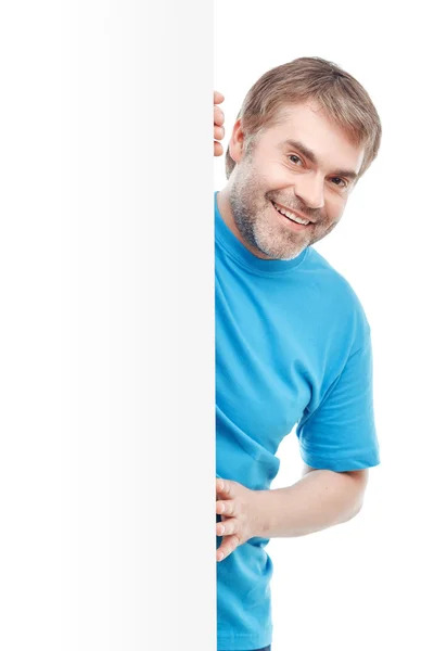 Man looking out of white wall — Stock Photo, Image