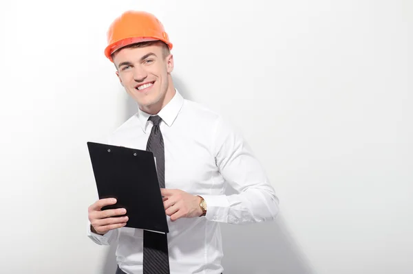 Smiling foreman holding folder on isolated — Stock Photo, Image