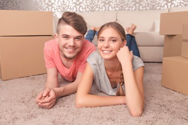 Pleasant couple lying on the floor 