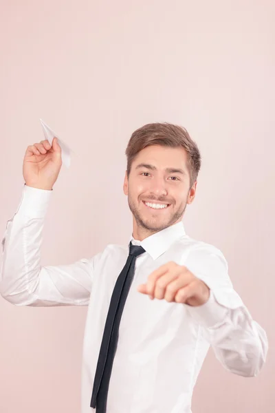 Pleasant lawyer holding paper plane — Stok fotoğraf