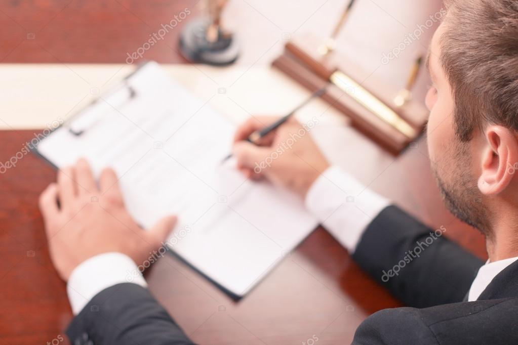 Pleasant lawyer signing papers 