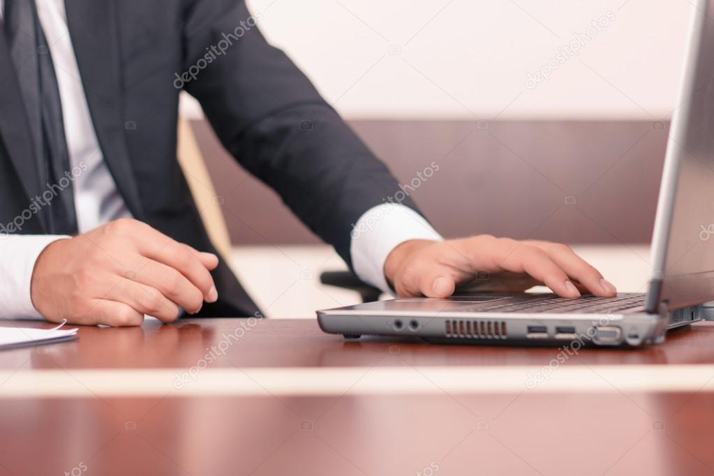 Handsome lawyer working on his laptop 