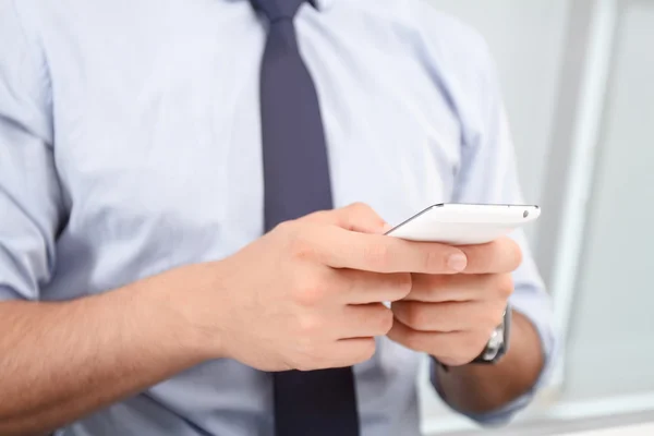 Call center operator holding mobile phone — Stock Photo, Image