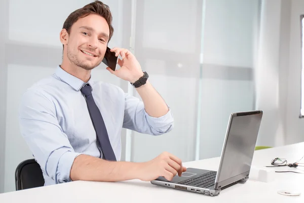 Call center operator holding mobile phone — Stock Photo, Image