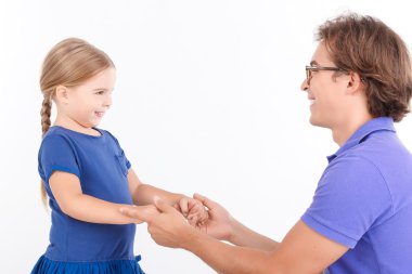 Nice daughter holding hands of father.