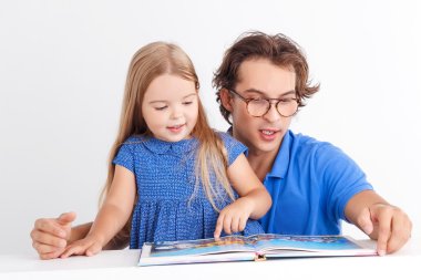 Father reading with his daughter 