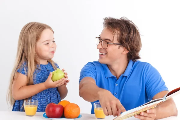 Father and daughter sitting at the table — Stock Photo, Image