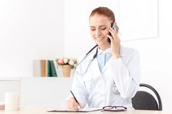 Professional doctor sitting at the table — Stock Photo, Image