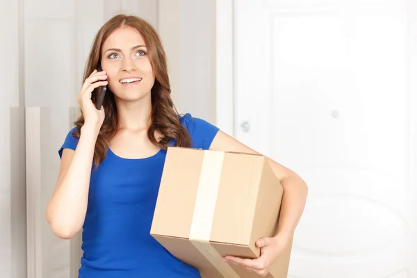 Cheerful woman holding box — Stock Photo, Image