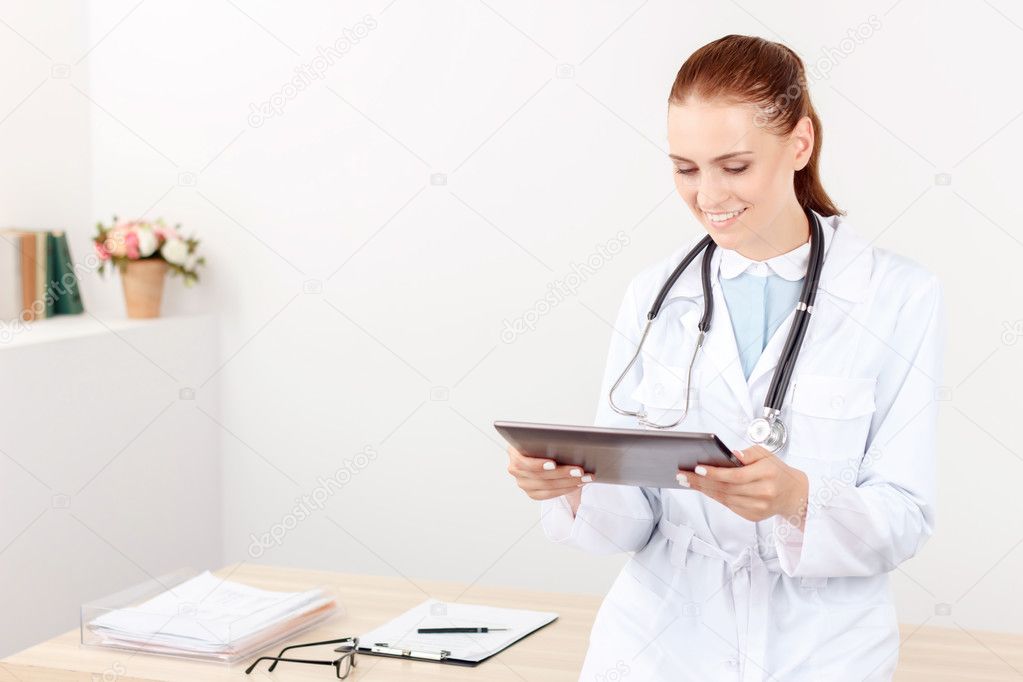 Vivacious doctor holding laptop
